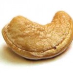 Freshly roasted cashew nut (Anacardium occidentale) on white background